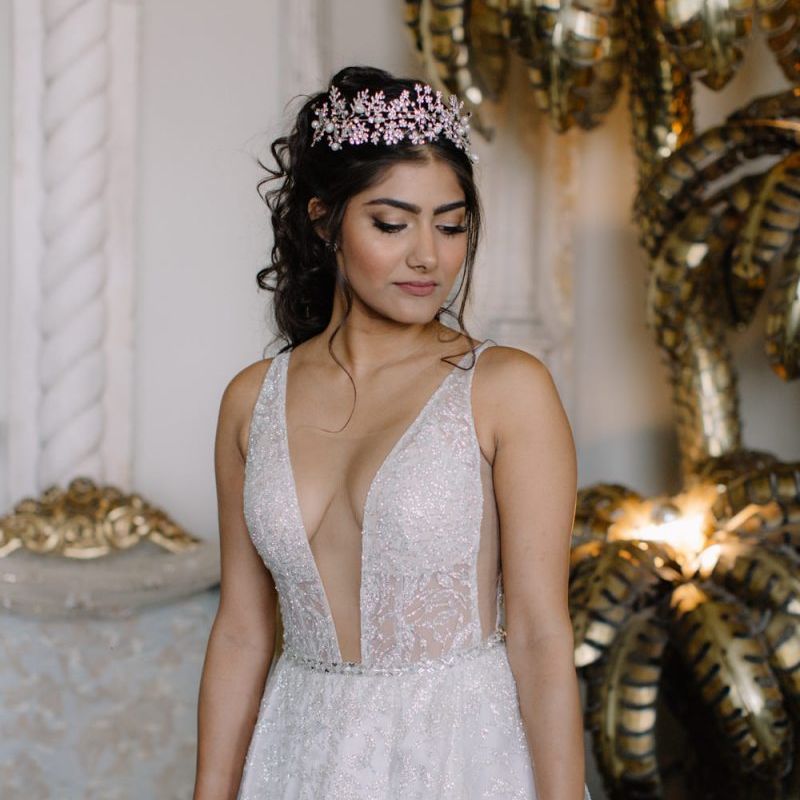 Bride in Berta Bridal gown with plunging neckline and crown