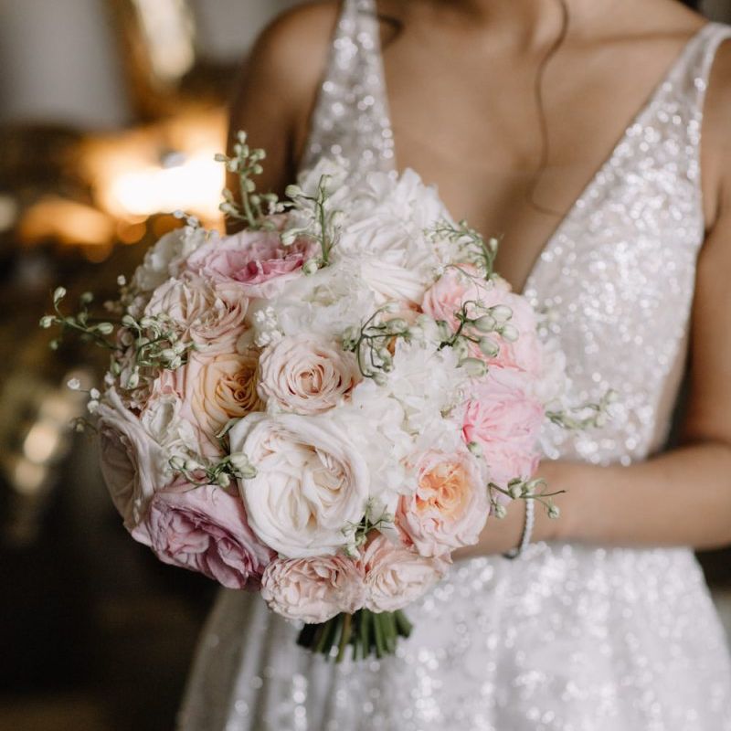 Bride in Berta Bridal gown holding a romantic blush pink and white wedding bouquet with David Austin roses