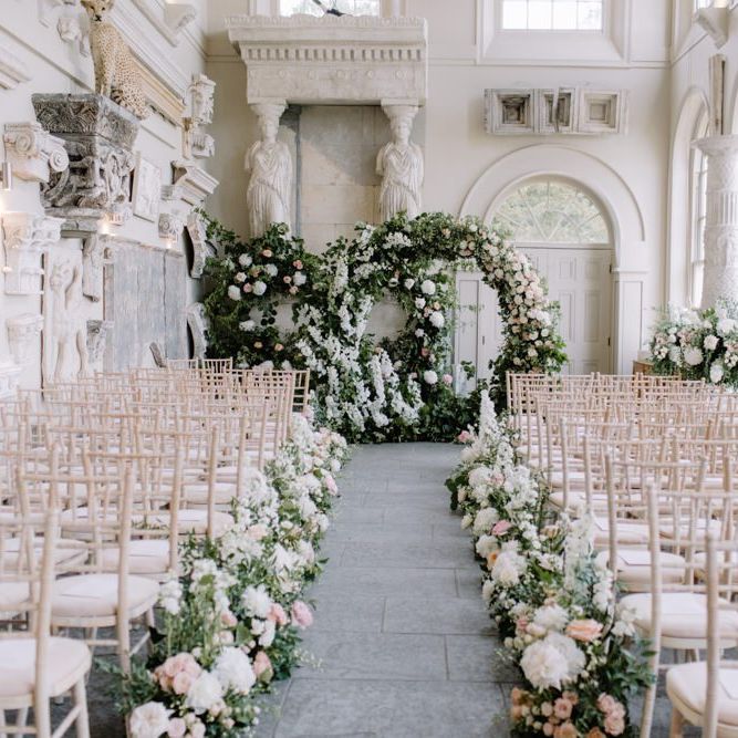 Aisle and altar wedding flowers at Aynhoe Park Orangery