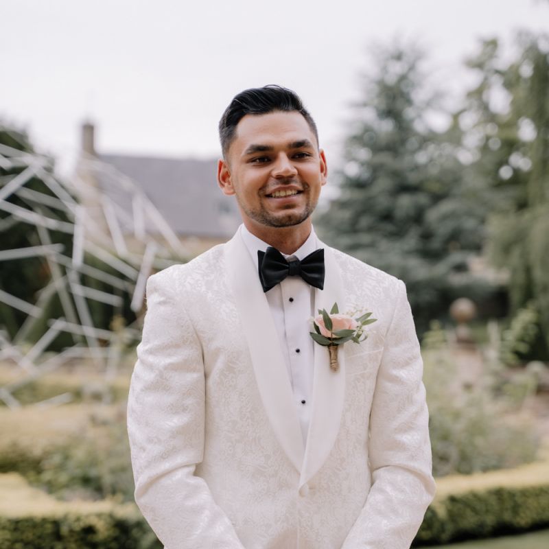 Groom in white dinner jacket