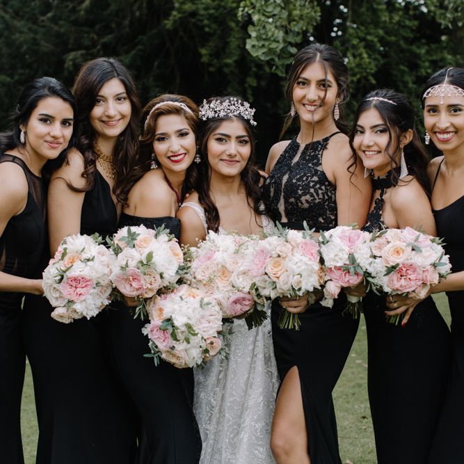 Bridal party portrait with bridesmaids in black dresses and bride in Berta Bridal gown