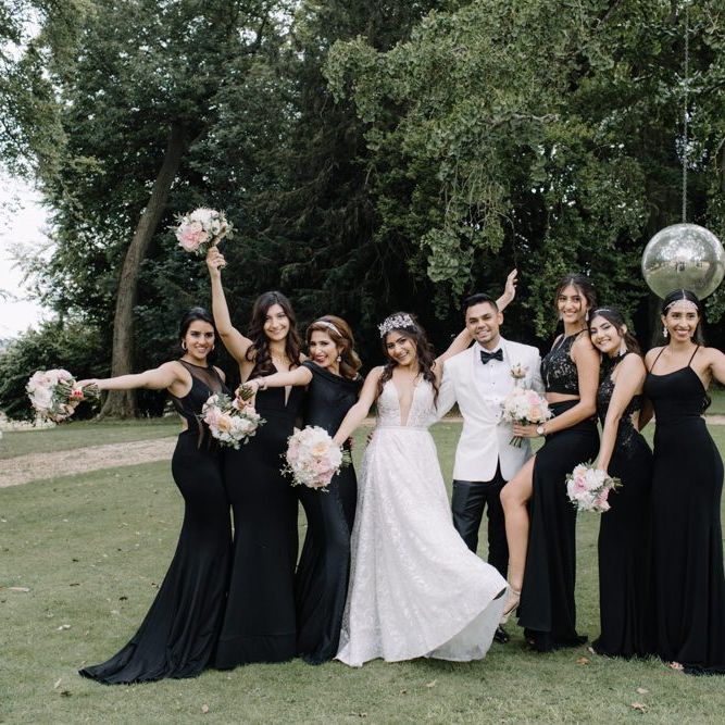 Bride and groom with bridesmaids at black tie wedding with Berta Bridal gown