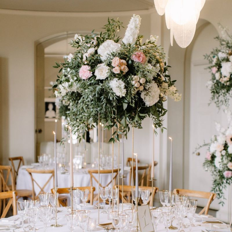 Blush pink and white floral centrepiece on high gold stand