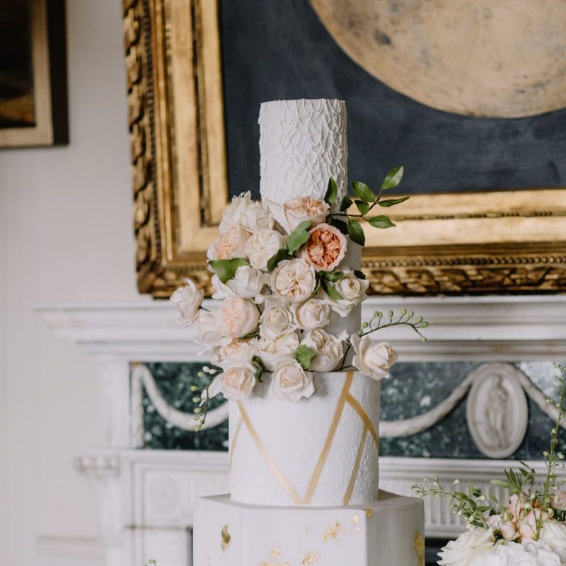 Luxury wedding cake with gold detail and blush wedding flowers