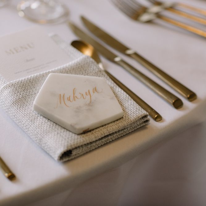 Marble name place setting with gold font for luxury wedding at Aynhoe Park with Berta Bridal gown