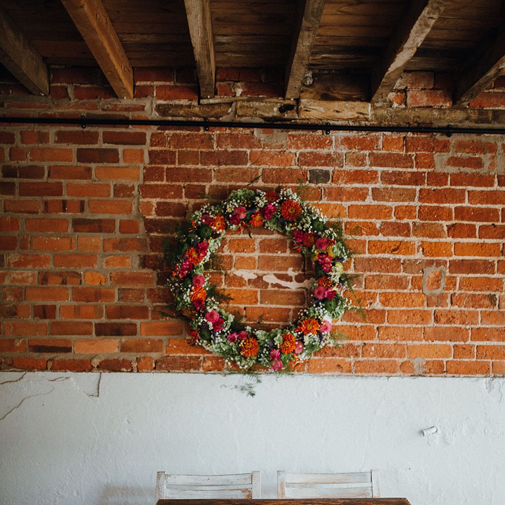 Floral Wreath Altar | Rustic Bureau | Persian Rugs and Autumn Leaves Lining Aisle | Mariachi Band and Persian Rug Aisle for Autumn Wedding | Leah Lombardi Weddings