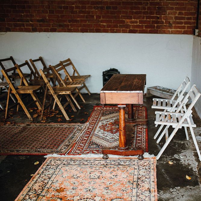 Persian Rugs and Autumn Leaves Lining Aisle | Floral Wreath Altar | Rustic Bureau | Mariachi Band and Persian Rug Aisle for Autumn Wedding | Leah Lombardi Weddings