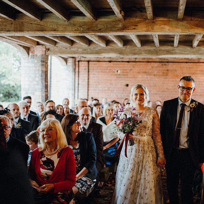 Bride in Bead Embellished Needle &amp; Thread Gown with Cascading Tulle Skirt and Semi Sheer Sleeves | Purple, Orange and Pink Flowers with Foliage and Maroon Trailing Ribbon | Entrance of the Bride | Mariachi Band and Persian Rug Aisle for Autumn Wedding | Leah Lombardi Weddings