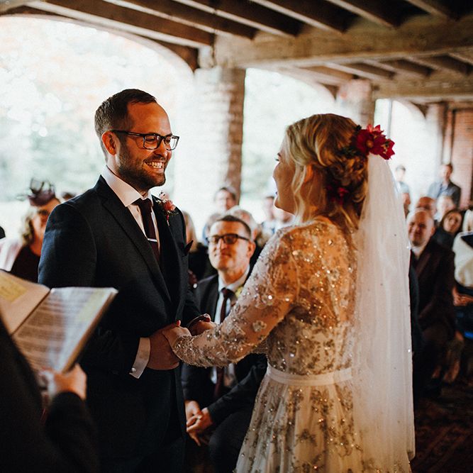 Bride in Bead Embellished Needle &amp; Thread Gown with Cascading Tulle Skirt and Semi Sheer Sleeves | Elbow Length Veil | Bridal Up Do with Pink Hair Flowers | Groom in Check Blue Three Piece Suit by T.M.Lewin with Maroon Tie and Pocket Square | Wedding Ceremony at Pimhill Barn | Mariachi Band and Persian Rug Aisle for Autumn Wedding | Leah Lombardi Weddings