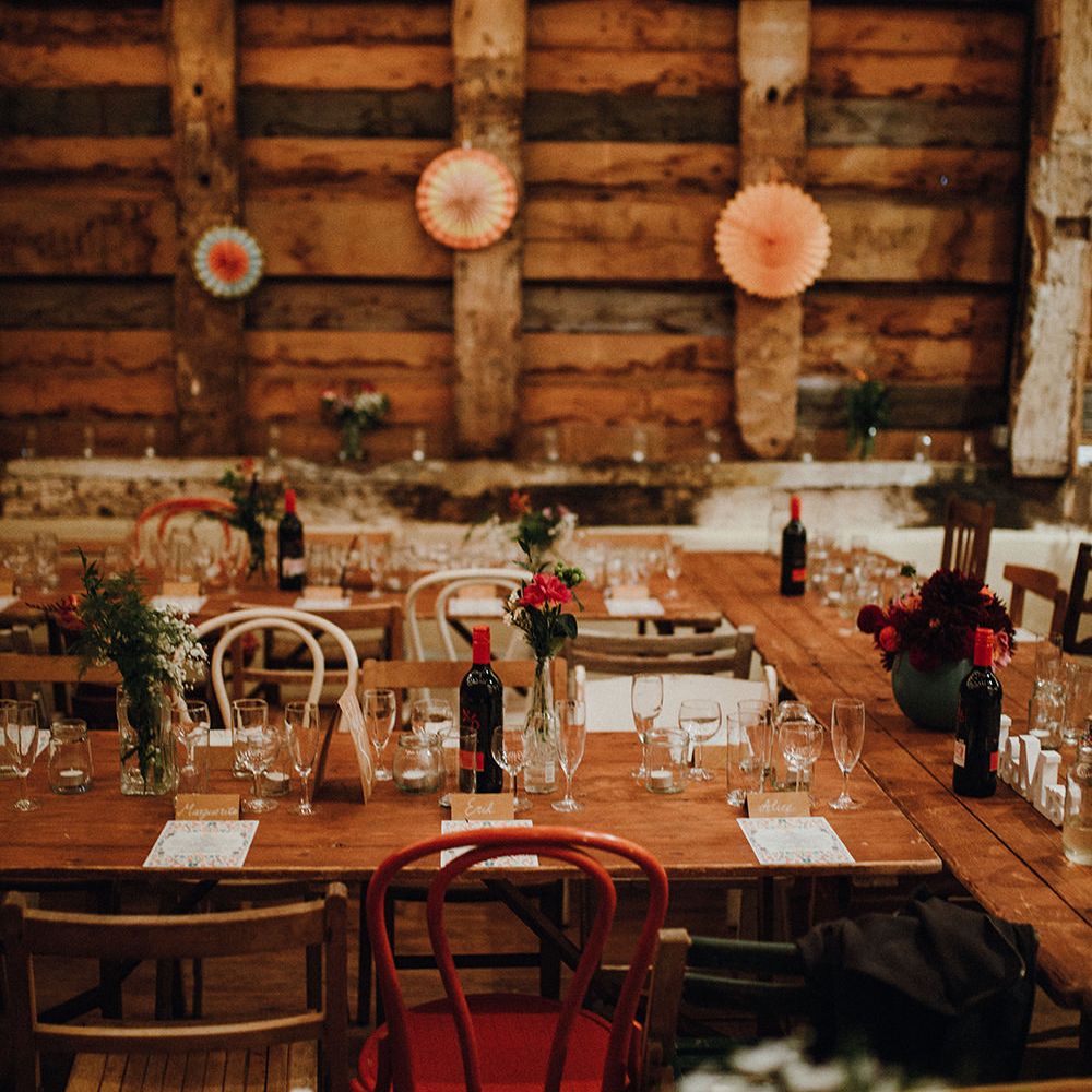 Wooden Banquet Tables | Mismatched Rustic Chairs | Paper Fans | Kraft Place Settings | Pink, Orange and Maroon Flowers for Tables | Mariachi Band and Persian Rug Aisle for Autumn Wedding | Leah Lombardi Weddings