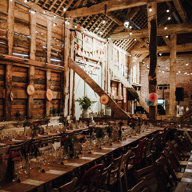 Wooden Banquet Tables | Mismatched Rustic Chairs | Paper Fans | Festoon Lights | Bunting | Kraft Place Settings | Pink, Orange and Maroon Flowers for Tables | Mariachi Band and Persian Rug Aisle for Autumn Wedding | Leah Lombardi Weddings