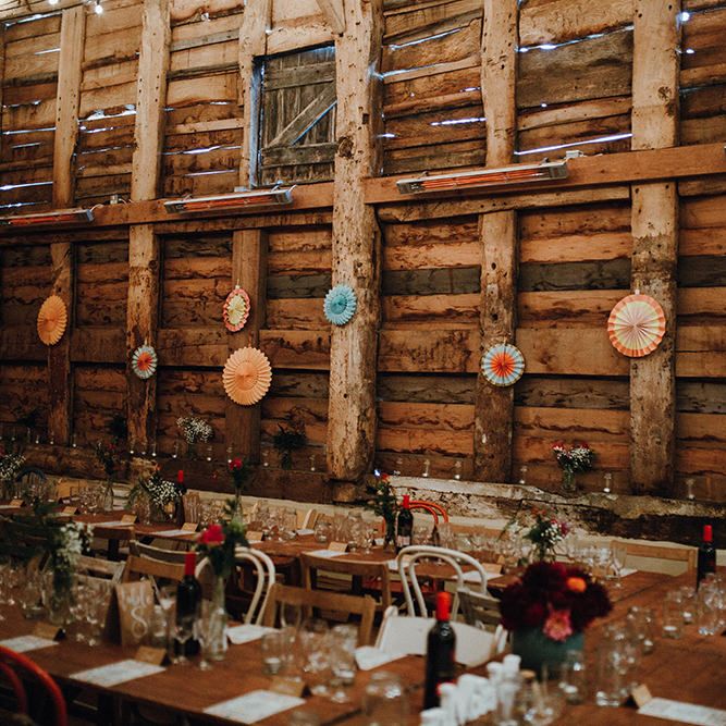 Wooden Banquet Tables | Mismatched Rustic Chairs | Paper Fans | Kraft Place Settings | Pink, Orange and Maroon Flowers for Tables | Mariachi Band and Persian Rug Aisle for Autumn Wedding | Leah Lombardi Weddings
