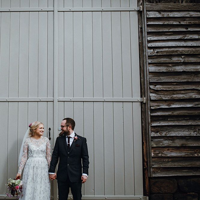 Bride in Bead Embellished Needle &amp; Thread Gown with Cascading Tulle Skirt and Semi Sheer Sleeves | Elbow Length Veil | Bridal Up Do with Pink Hair Flowers | Groom in Check Blue Three Piece Suit by T.M.Lewin with Maroon Tie and Pocket Square | Purple, Orange and Pink Flowers with Foliage and Maroon Trailing Ribbon | Mariachi Band and Persian Rug Aisle for Autumn Wedding | Leah Lombardi Weddings