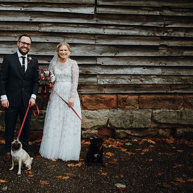 Bride in Bead Embellished Needle &amp; Thread Gown with Cascading Tulle Skirt and Semi Sheer Sleeves | Elbow Length Veil | Bridal Up Do with Pink Hair Flowers | Groom in Check Blue Three Piece Suit by T.M.Lewin with Maroon Tie and Pocket Square | Purple, Orange and Pink Flowers with Foliage and Maroon Trailing Ribbon | Pet Pugs Baxter and Bertie | Mariachi Band and Persian Rug Aisle for Autumn Wedding | Leah Lombardi Weddings