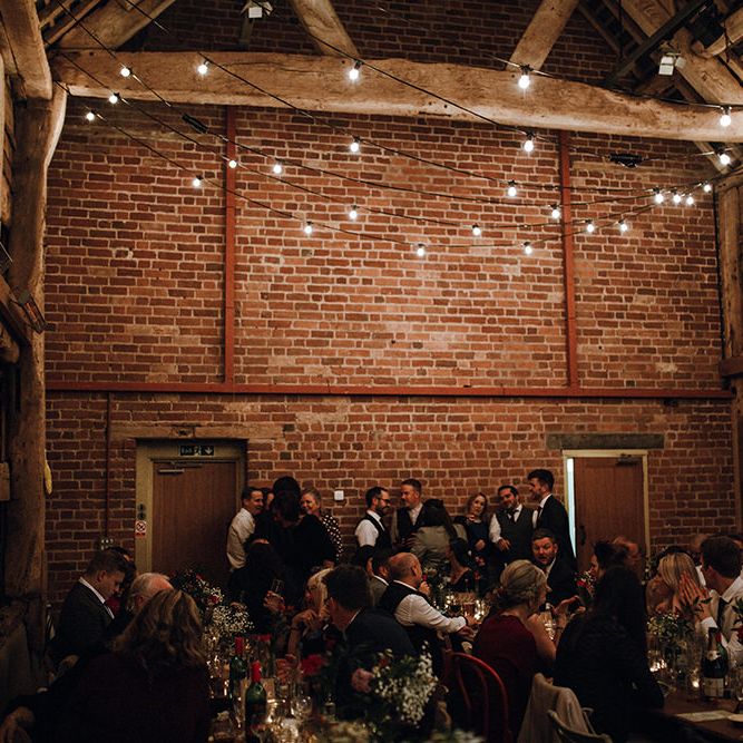 Festoon Lights | Paper Fans | Wooden Banqueting Tables | Wedding Reception at Pimhill Barn | Mariachi Band and Persian Rug Aisle for Autumn Wedding | Leah Lombardi Weddings