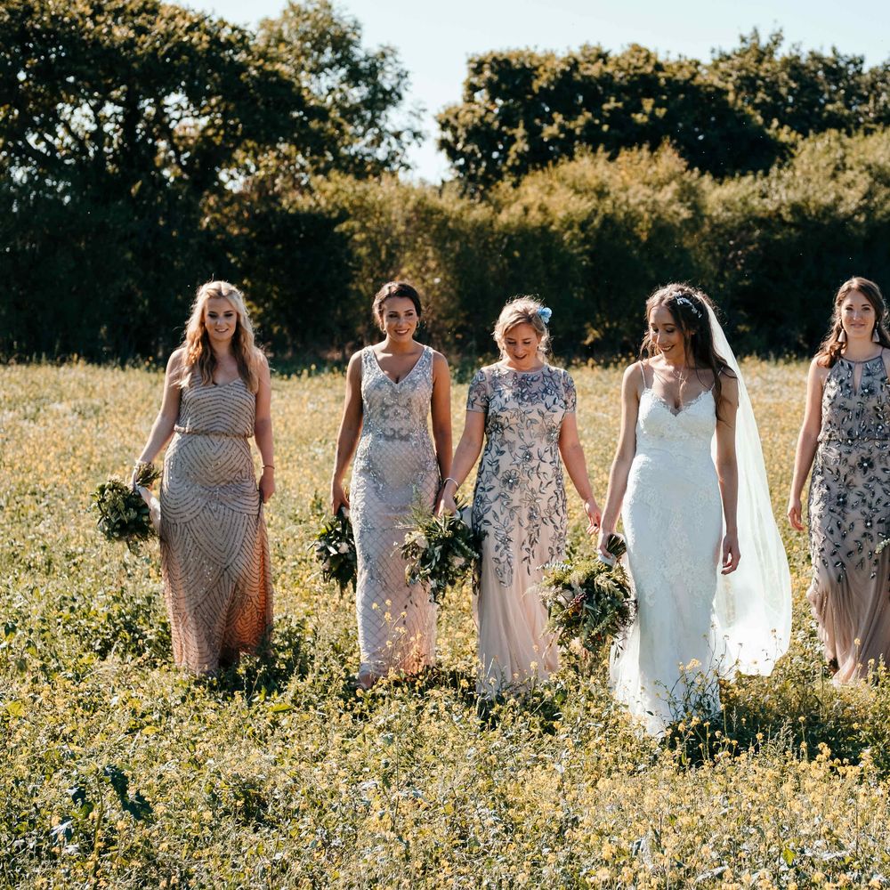 Stunning Bridesmaids Jewelled Dresses. Marquee in Jersey. Foliage Installations. Stationery by Quints of Jersey. Bride Wears Enzoani. Photography by Max Burnett