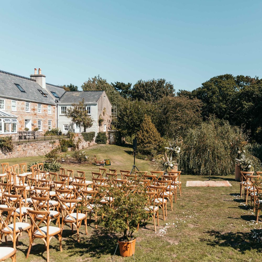 Outdoor Wedding Set Up. Marquee in Jersey. Foliage Installations. Stationery by Quints of Jersey. Bride Wears Enzoani. Photography by Max Burnett