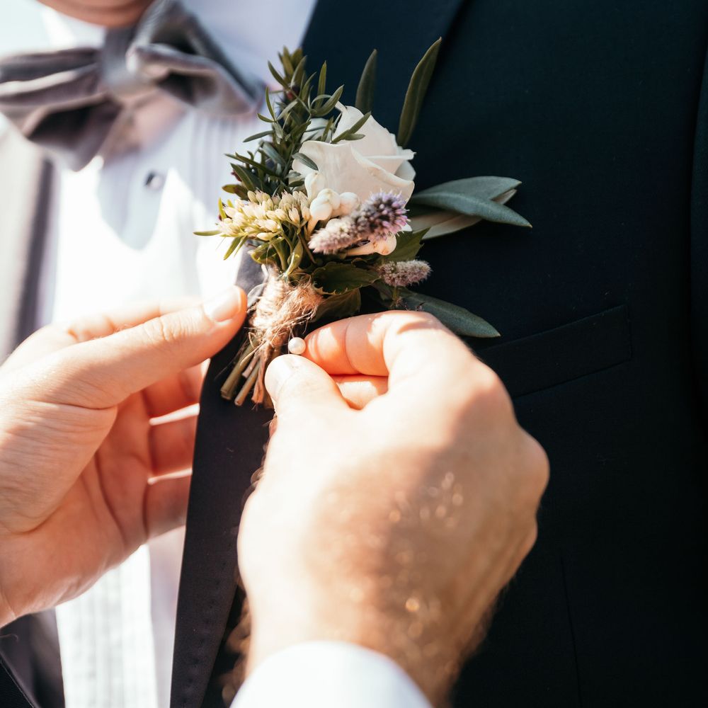 Blush Rose Buttonhole.  Grooms Morning Preparations. Marquee in Jersey. Foliage Installations. Stationery by Quints of Jersey. Bride Wears Enzoani. Photography by Max Burnett