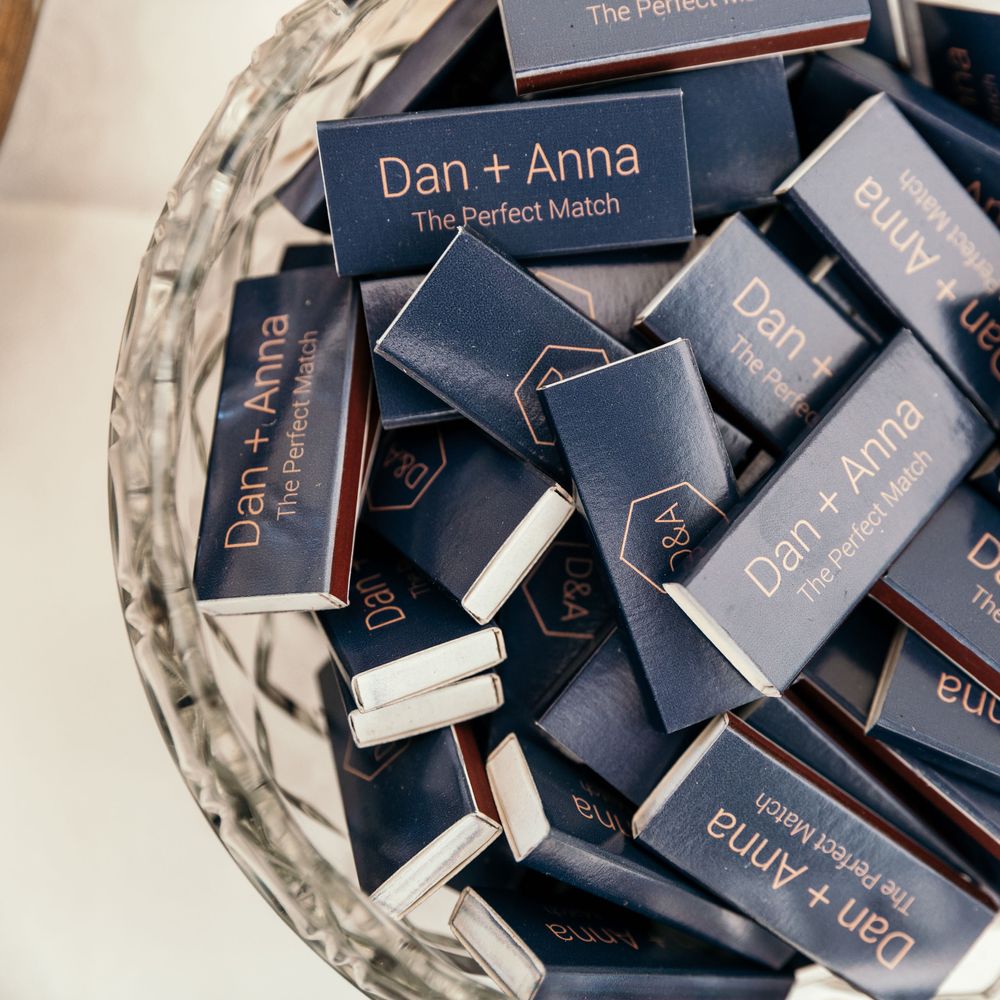 Personalised Matches Favours. Marquee in Jersey. Foliage Installations. Stationery by Quints of Jersey. Bride Wears Enzoani. Photography by Max Burnett