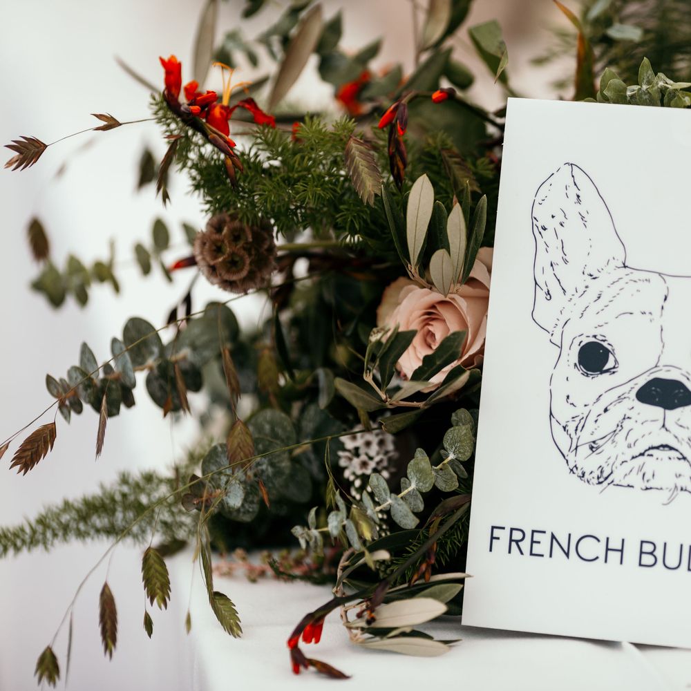 Table Names as Dogs After Bride's Experience As A Vet. Marquee in Jersey. Foliage Installations. Stationery by Quints of Jersey. Bride Wears Enzoani. Photography by Max Burnett