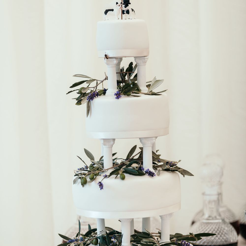 Marks and Spencer Plain White Iced Cake. Marquee in Jersey. Foliage Installations. Stationery by Quints of Jersey. Bride Wears Enzoani. Photography by Max Burnett