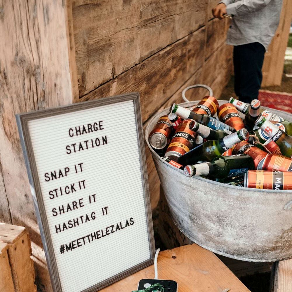 Mobile Phone Charging Station for Guests. Marquee in Jersey. Foliage Installations. Stationery by Quints of Jersey. Bride Wears Enzoani. Photography by Max Burnett