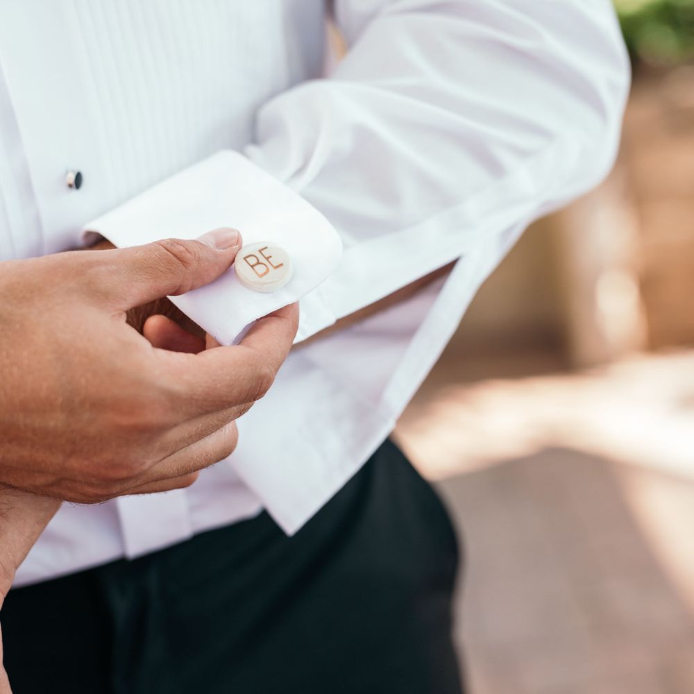Personalised Cufflinks. Marquee in Jersey. Foliage Installations. Stationery by Quints of Jersey. Bride Wears Enzoani. Photography by Max Burnett