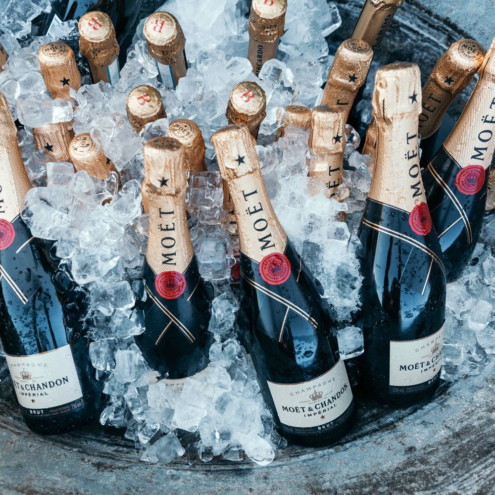 Moet Mini Bottles. Marquee in Jersey. Foliage Installations. Stationery by Quints of Jersey. Bride Wears Enzoani. Photography by Max Burnett