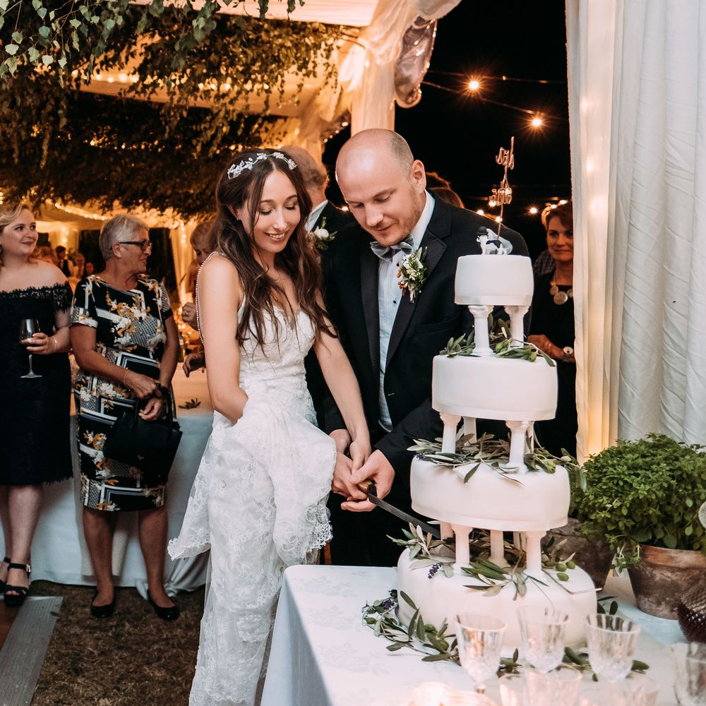 Marks and Spencer's Plain White Iced Wedding Cake. Marquee in Jersey. Foliage Installations. Stationery by Quints of Jersey. Bride Wears Enzoani. Photography by Max Burnett