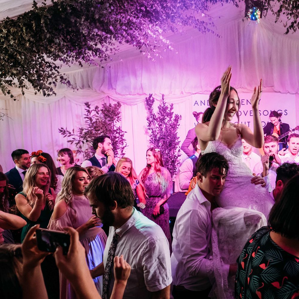 Wedding Dance. Lighting for Wedding. Marquee in Jersey. Foliage Installations. Stationery by Quints of Jersey. Bride Wears Enzoani. Photography by Max Burnett