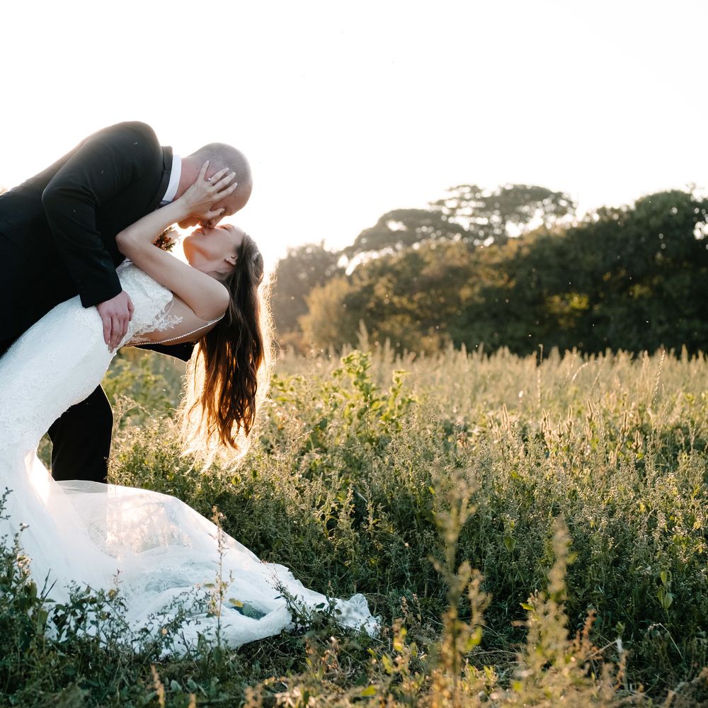 Enzoani Backless Dress. Marquee in Jersey. Foliage Installations. Stationery by Quints of Jersey. Bride Wears Enzoani. Photography by Max Burnett