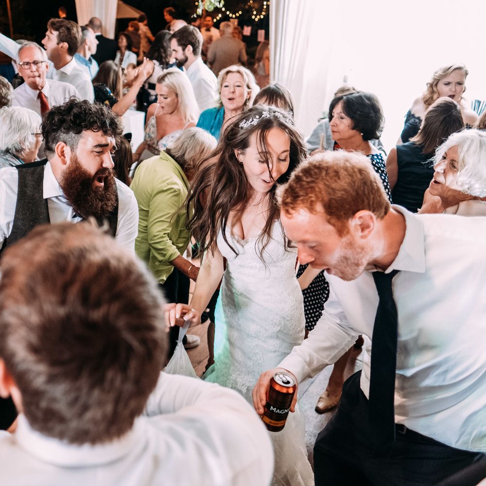 Epic Wedding Reception. Marquee in Jersey. Foliage Installations. Stationery by Quints of Jersey. Bride Wears Enzoani. Photography by Max Burnett
