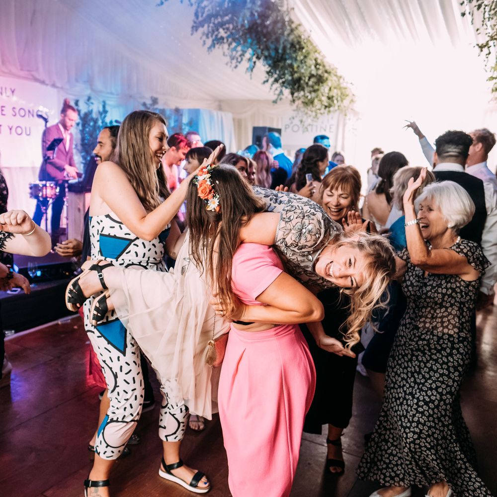 Epic Wedding Reception. Marquee in Jersey. Foliage Installations. Stationery by Quints of Jersey. Bride Wears Enzoani. Photography by Max Burnett