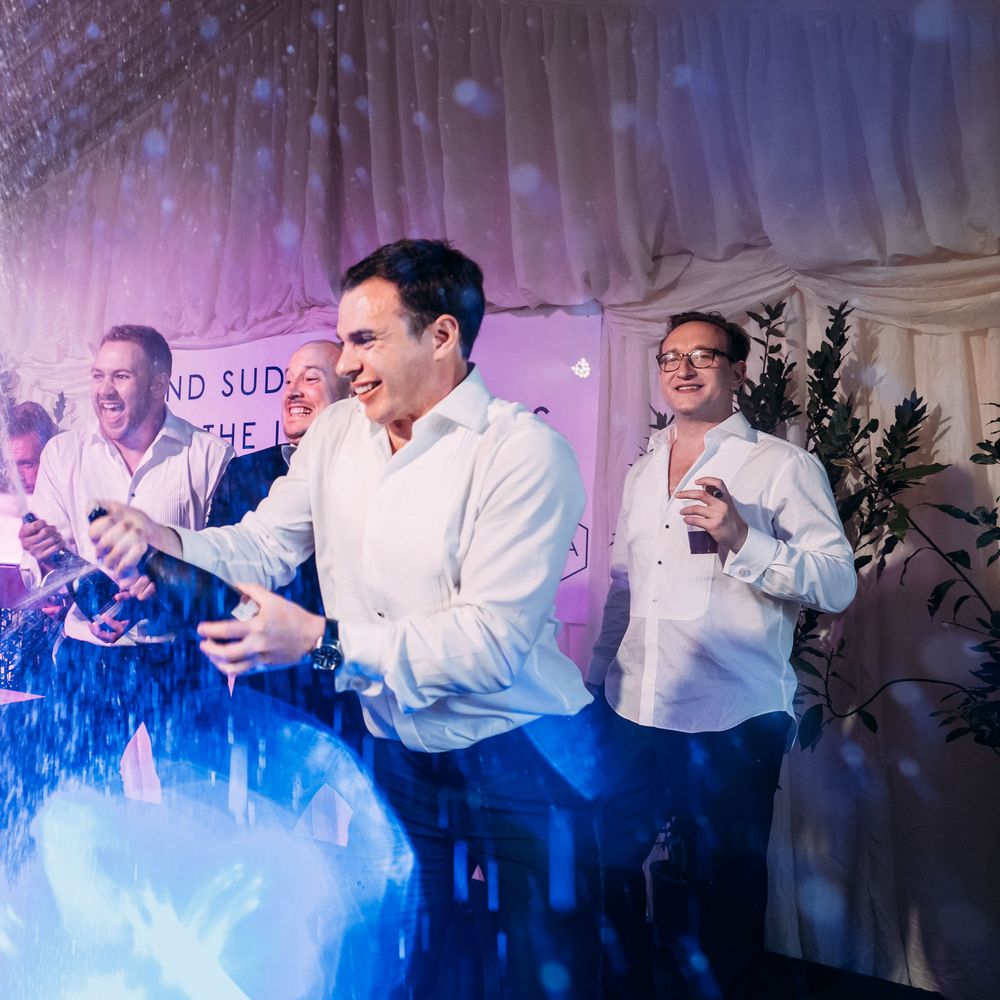 Epic Wedding Reception. Marquee in Jersey. Foliage Installations. Stationery by Quints of Jersey. Bride Wears Enzoani. Photography by Max Burnett