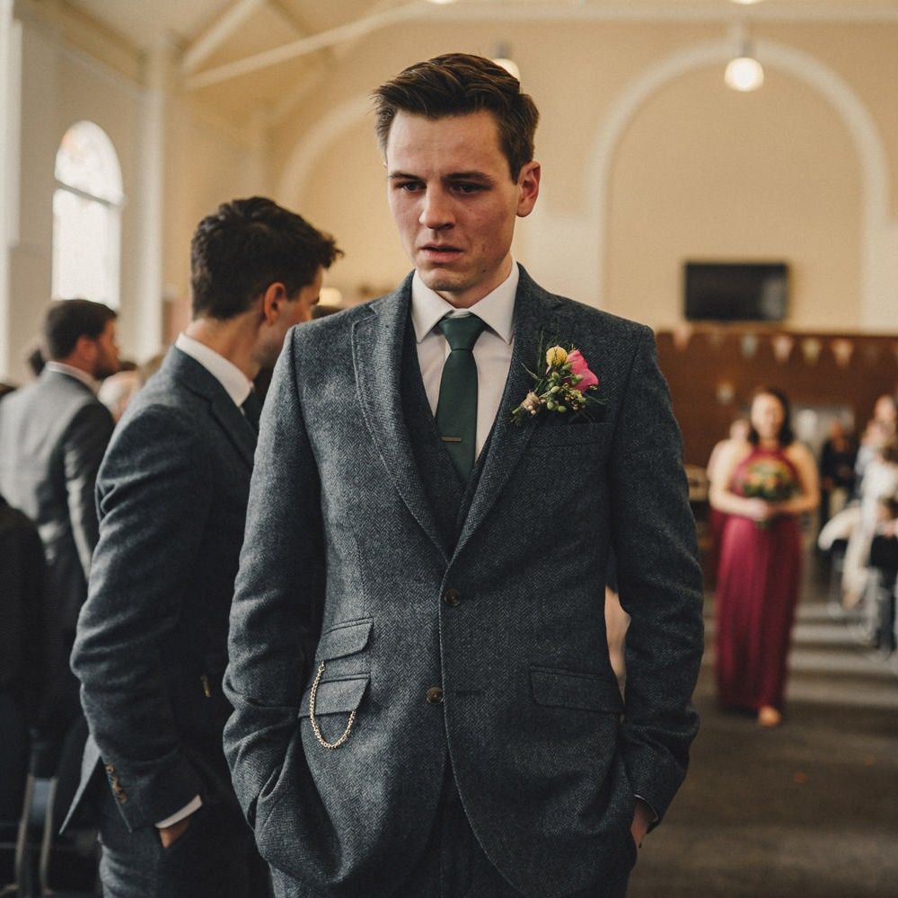 Groom in wool suit waiting at the altar