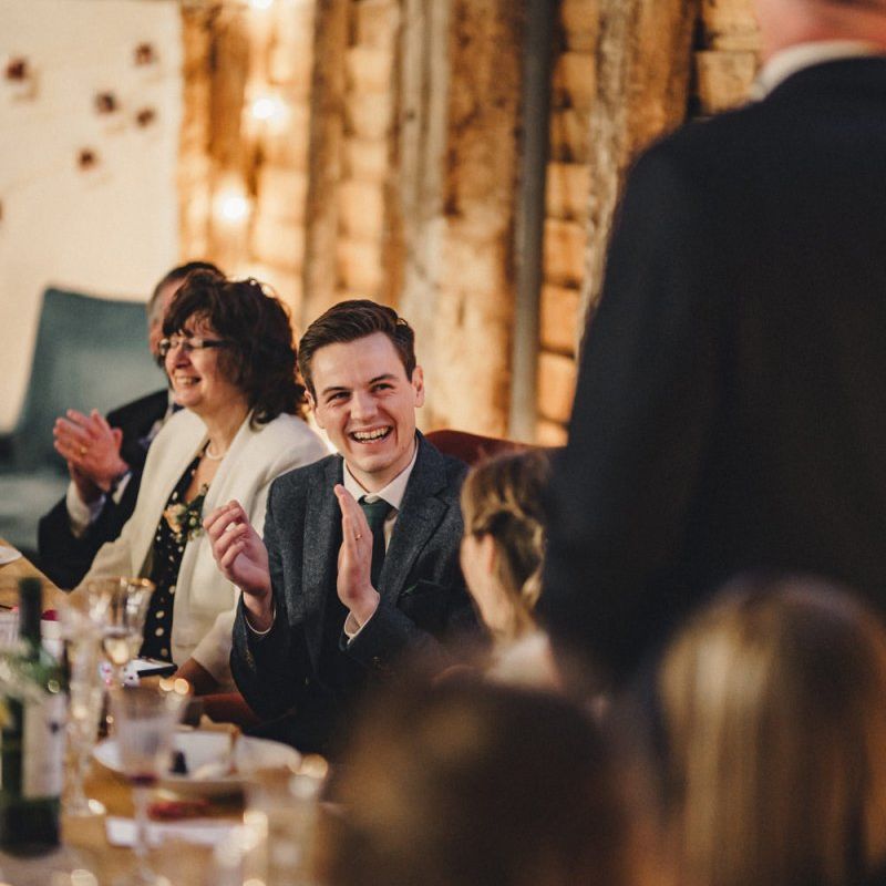 Groom laughing during the wedding speeches