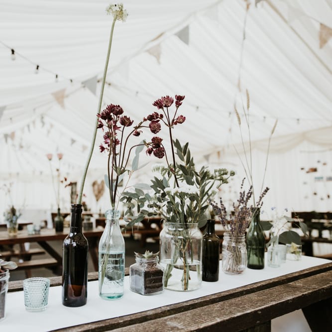 Budvase Flowers And Trestle Tables For Marquee Wedding // Eco Friendly Budget Wedding At Slade Farm In Wales With Images From Francesca Hill Photographer
