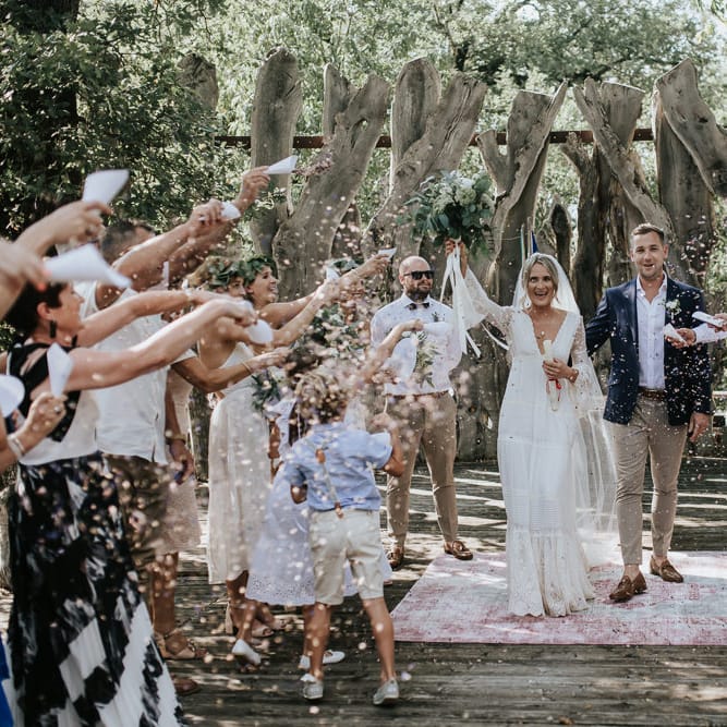 Confetti Moment | Bride in Spell &amp; the Gypsy Collective Bell Sleeve Wedding Dress | Groom in Chino's &amp; Blazer | Outdoor Bohemian Destination Wedding at La Selva, Tuscany | Damien Milan Photography