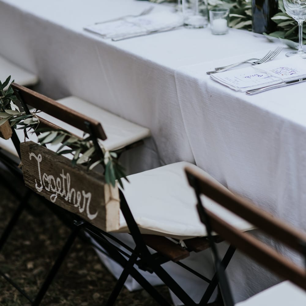 Wooden Together Chair Back Decor | Festoon Lit Outdoor Reception | Bohemian Destination Wedding at La Selva, Tuscany | Damien Milan Photography