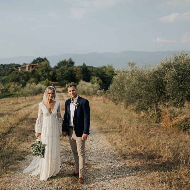 Bride in Spell &amp; the Gypsy Collective Bell Sleeve Wedding Dress | Groom in Chino's &amp; Blazer | Outdoor Bohemian Destination Wedding at La Selva, Tuscany | Damien Milan Photography
