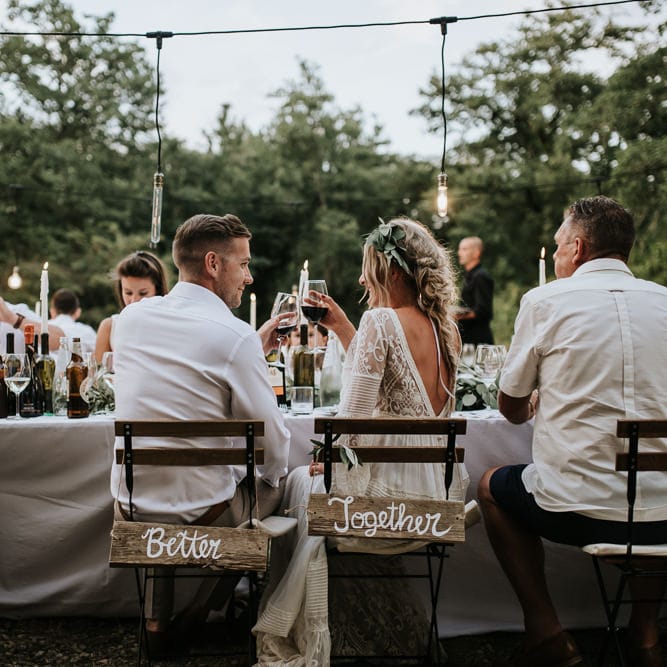 Wooden Chair Back Decor | Bride in Spell &amp; the Gypsy Collective Bell Sleeve Wedding Dress | Groom in Chino's &amp; Blazer | Outdoor Bohemian Destination Wedding at La Selva, Tuscany | Damien Milan Photography
