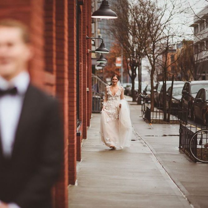 Bride in Marchesa gown walks towards groom for First Look