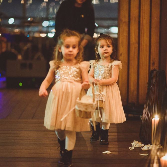 Cute flower girls walks down the aisle