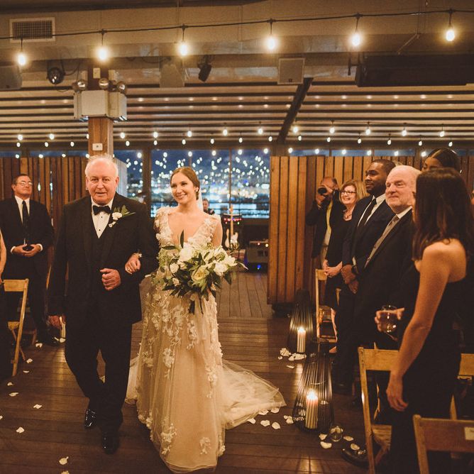 Bride in Marchesa bridal gown walks down the aisle