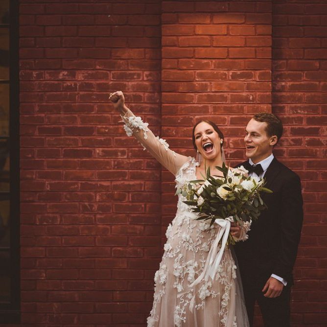 Bride in Marchesa bridal gown celebrates