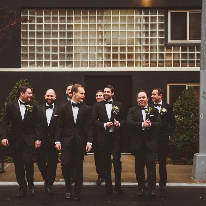 Groom with his groomsmen in matching tuxedos