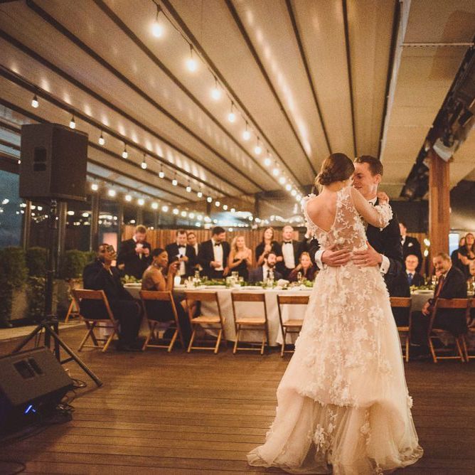 Bride in Marchesa wedding dress with groom during first dance