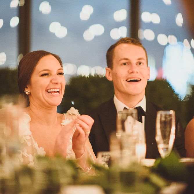 Bride and groom enjoy the wedding speeches