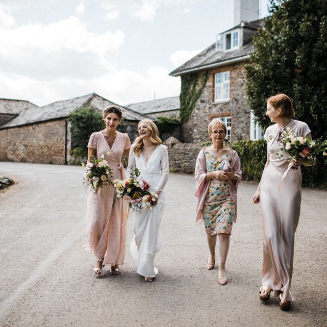 Bridal Party in Blush Pink Dresses Walking to the Wedding Ceremony
