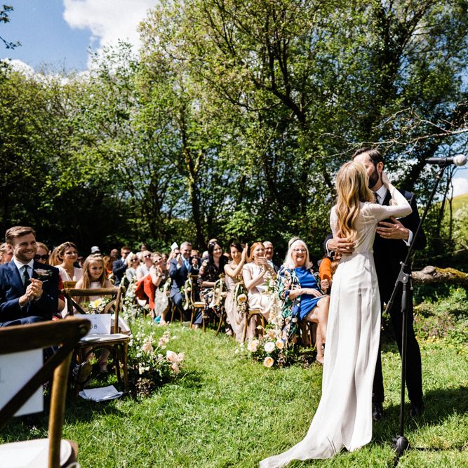 Bride and Groom Kiss at Outdoor Anran Wedding Ceremony